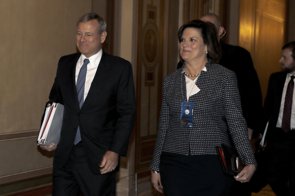 Supreme Court Chief Justice John Roberts, left, arrives at the Capitol in Washington, Tuesday, Jan. 21, 2020. President Donald Trump's impeachment trial quickly burst into a partisan fight Tuesday as proceedings began unfolding at the Capitol. Democrats objected strongly to rules proposed by the Republican leader for compressed arguments and a speedy trial. (AP Photo/Julio Cortez)