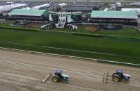 <p>Tractors groom the track before the 144th running of the Kentucky Derby at Churchill Downs in Louisville, Ky., May 5, 2018. (Photo: Jamie Rhodes/USA TODAY Sports/Reuters) </p>