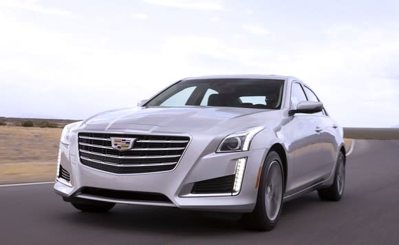 A silver Cadillac CTS luxury sedan on a country road.