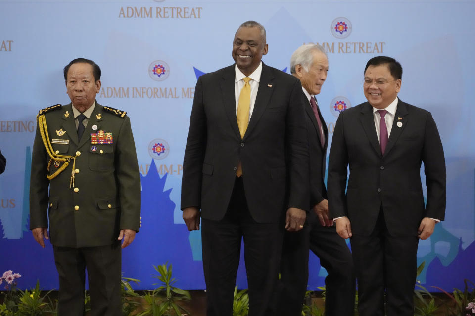 U.S. Secretary of Defense Lloyd J. Austin III, center, poses for a group photo together with Cambodia's Defense Minister Tea Banh, left, Philippines Senior Undersecretary Jose Faustino Jr., right, as Singapore Defense Minister Ng Eng Hen walks at the venue of the Association of Southeast Asian Nations (ASEAN) during the ASEAN-United State Defense Ministers' Informal Meeting in Siem Reap, Cambodia, Tuesday, Nov. 22, 2022. (AP Photo/Heng Sinith)