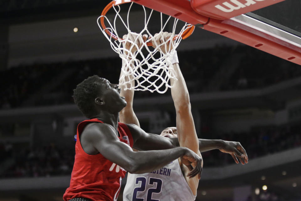 Nebraska's Akol Arop. left, fouls Northwestern's Pete Nance (22) as he attempts to dunk, during the first half of an NCAA college basketball game in Lincoln, Neb., Sunday, March 1, 2020. (AP Photo/Nati Harnik)