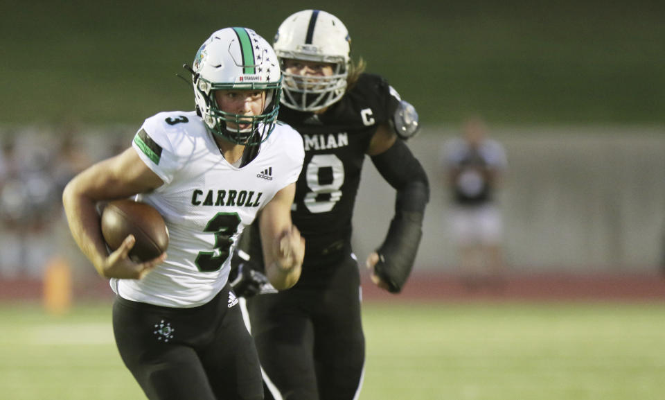 FILE - Southlake Carroll quarterback Quinn Ewers (3) runs for a first down against Permian during the first half of a high school football game in Odessa, Texas, in this Friday night Sept. 13, 2019, file photo. Third-year Ohio State coach Ryan Day opens a preseason camp for the first time without a good idea of who will be the starting quarterback. Quinn Ewers, the top quarterback prospect in the class of 2022 who says he is skipping his senior year of high school in Texas and plans to enroll at Ohio State is the wildcard. (Ben Powell/Odessa American via AP, File)