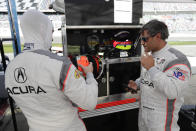 Dane Cameron, left, prepares to go out on the track after Juan Pablo Montoya, right, comes in for a break during testing for the upcoming Rolex 24 hour auto race at Daytona International Speedway, Friday, Jan. 3, 2020, in Daytona Beach, Fla. (AP Photo/John Raoux)