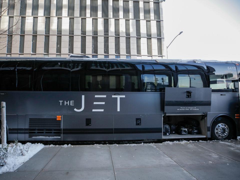 A matte black bus that reads "The Jet" on the side.