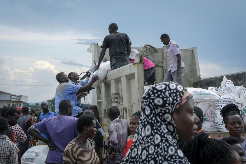 People await a food distribution from a truck aimed to help those affected by the travel restrictions imposed in an attempt to limit the spread of Ebola, at a football pitch in Mubende, Uganda Tuesday, Nov. 1, 2022. Ugandan health officials say they have controlled the spread of a strain of Ebola that has no proven vaccine, but there are pockets of resistance to health measures among some in rural communities where illiteracy is high and restrictions on movement and business activity have left many bitter. (AP Photo/Hajarah Nalwadda)