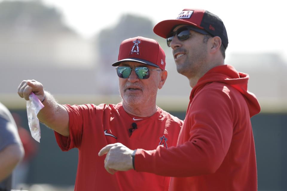 Angels manager Joe Maddon speaks with general manager Billy Eppler.