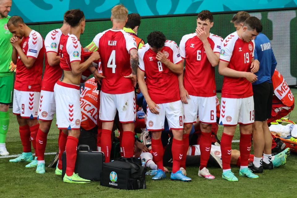 Denmark's players gather as paramedics attend to midfielder Christian Eriksen on Saturday.