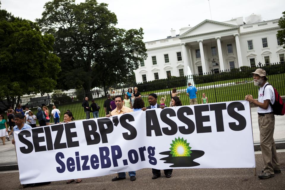 FILE- In this Tuesday, June 15, 2010, file photo, a group called "Seize BP" holds up an anti-BP sign in front of the White House, in Washington. The Obama administration put a temporary stop to new federal contracts with British oil company BP on Wednesday, Nov. 28, 2012, citing the company's "lack of business integrity" and criminal proceedings stemming from the Deepwater Horizon disaster in 2010. (AP Photo/Drew Angerer, File)