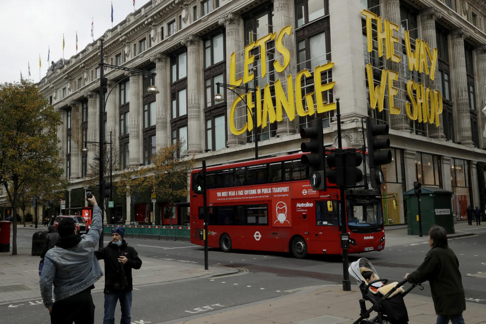 The words "Let's Change The Way We Shop" are displayed on the Selfridges department store on Oxford Street, which is temporarily closed for in-store browsing with online collection possible from a collection point, during England's second coronavirus lockdown, in London, Monday, Nov. 23, 2020. British Prime Minister Boris Johnson has announced plans for strict regional measures to combat COVID-19 after England's second lockdown ends Dec. 2, sparking a rebellion by members of his own party who say the move may do more harm than good. (AP Photo/Matt Dunham)