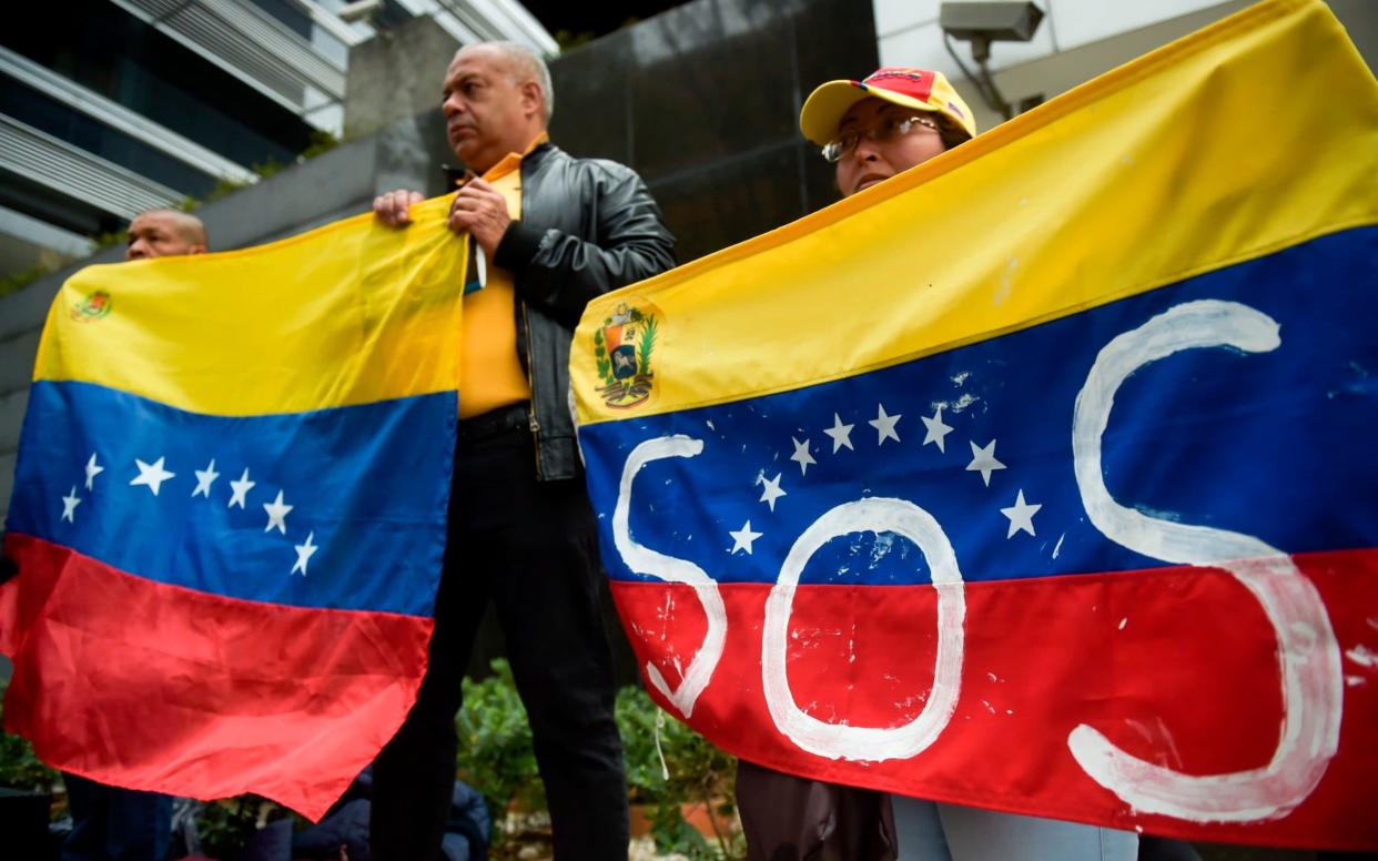 Protesters in Caracas demanding the delivery of aid, and asking President Nicolas Maduro to leave - AFP