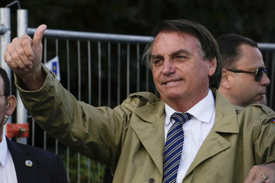 FILE - In this Nov. 2, 2021 file photo, Brazilian President Jair Bolsonaro gestures after attending a commemoration for Brazilian soldiers fallen during WWII, in Pistoia, Italy. Powerful businesses are urging Brazil's President Jair Bolsonaro to give up its long-standing resistance on key issues at this year's U.N. climate talks, arguing the country can't afford to pass up the chance to use its vast natural wealth in the fight against global warming. Last week, Brazil surprised observers by joining an international pledge to halt and reverse deforestation by 2030. (AP Photo/Andrew Medichini, file)