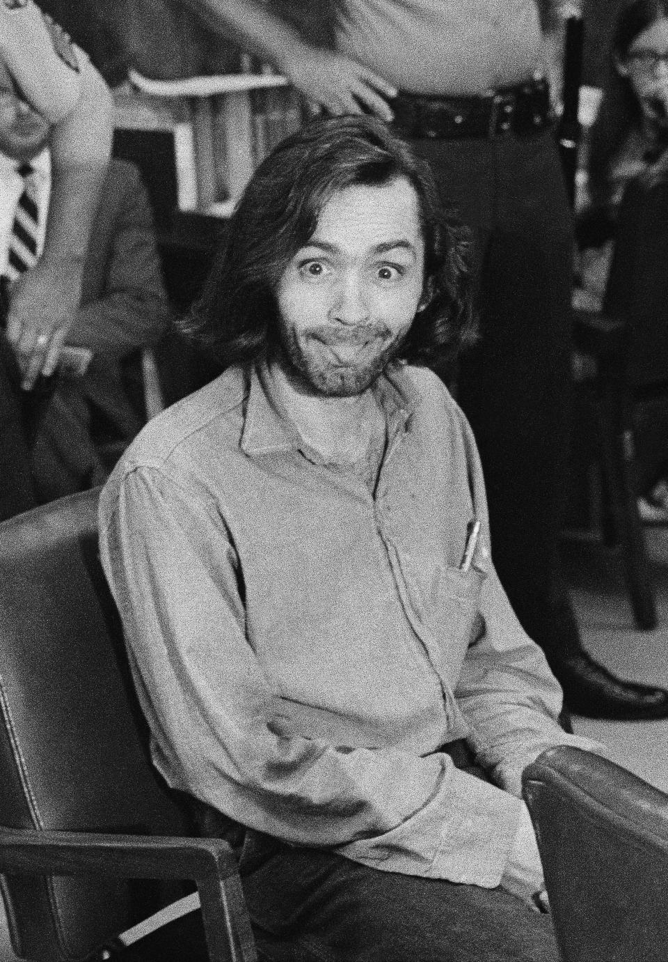 FILE - In this June 25, 1970, file photo, Charles Manson sticks his tongue out at photographers as he appears in a Santa Monica, Calif., courtroom on, charged with the slaying of musician Gary Hinman. Fifty years ago Charles Manson dispatched a group of disaffected young hippie followers on a two-night killing spree that terrorized Los Angeles and in the years since has come to represent the face of evil. On successive nights in August 1969, the so-called Manson family murdered seven people. (AP Photo/George Brich, File)