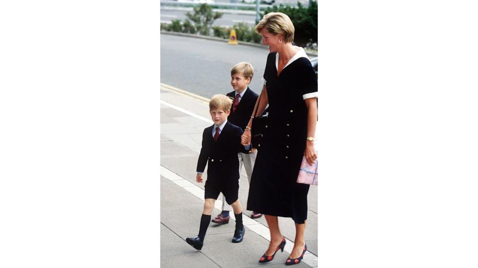 Princess Diana wearing a black dress with sons Prince William and Harry in September 1990