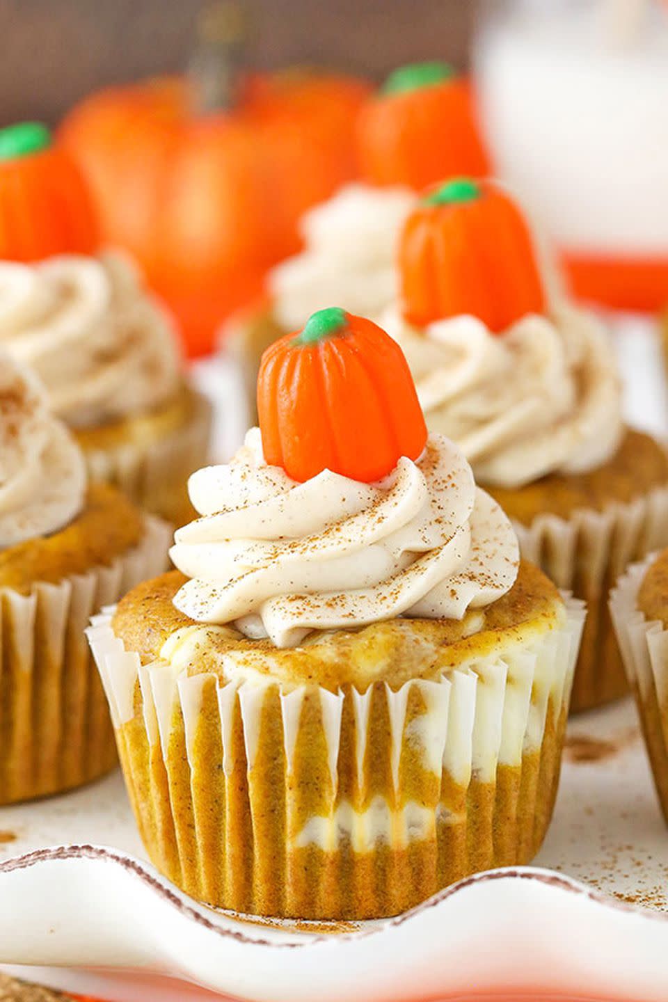 <p>Cheesecake swirls and a cinnamon-cream cheese frosting are great all year-round, but it's the sweet pumpkin candy topper that makes this treat fitting for fall. </p><p><strong>Get the recipe at <a href="https://www.lifeloveandsugar.com/2017/10/09/pumpkin-cheesecake-swirl-cupcakes/" rel="nofollow noopener" target="_blank" data-ylk="slk:Life, Love and Sugar;elm:context_link;itc:0;sec:content-canvas" class="link ">Life, Love and Sugar</a>.</strong></p>