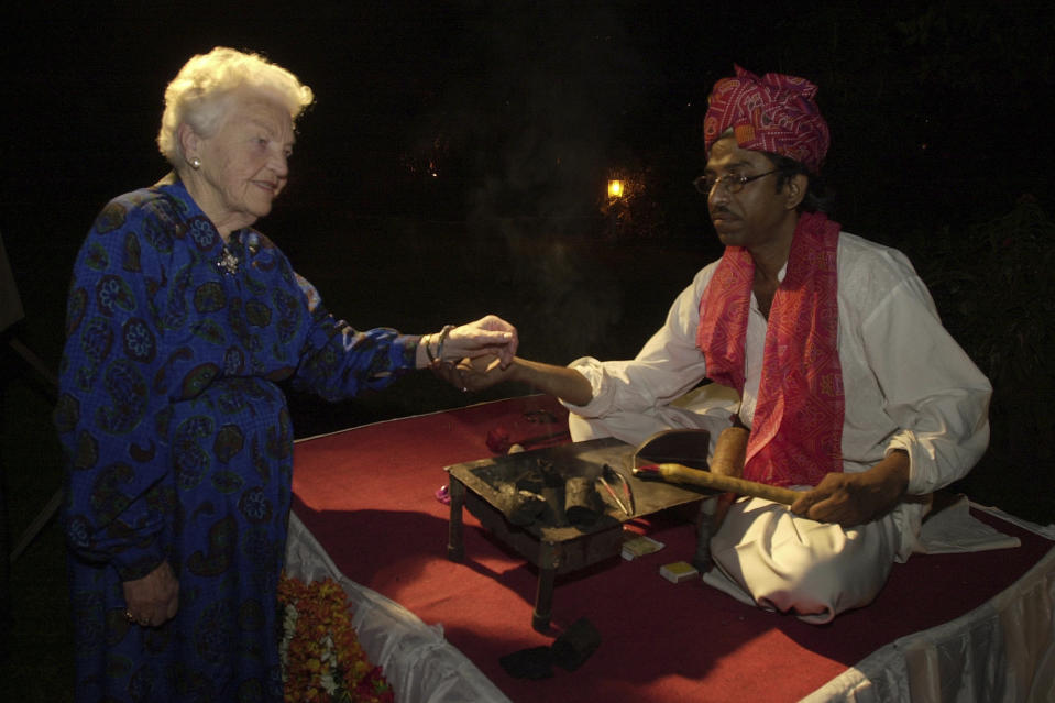 FILE - Mohammed Afzal, right, an Indian artist presents a bangle to Hazel McCallion, Mayor of Mississauga, Ontario, Canada, at a party to celebrate her 85th birthday in Bombay, India, Tuesday, Feb. 14, 2006. McCallion, who led one of Canada’s largest cities into her 90′s, died Sunday morning, Jan. 29, 2023, leaving behind a legacy of feisty advocacy and more than three decades of nearly unchallenged leadership. She was 101. (AP Photo/Aijaz Rahi, File)
