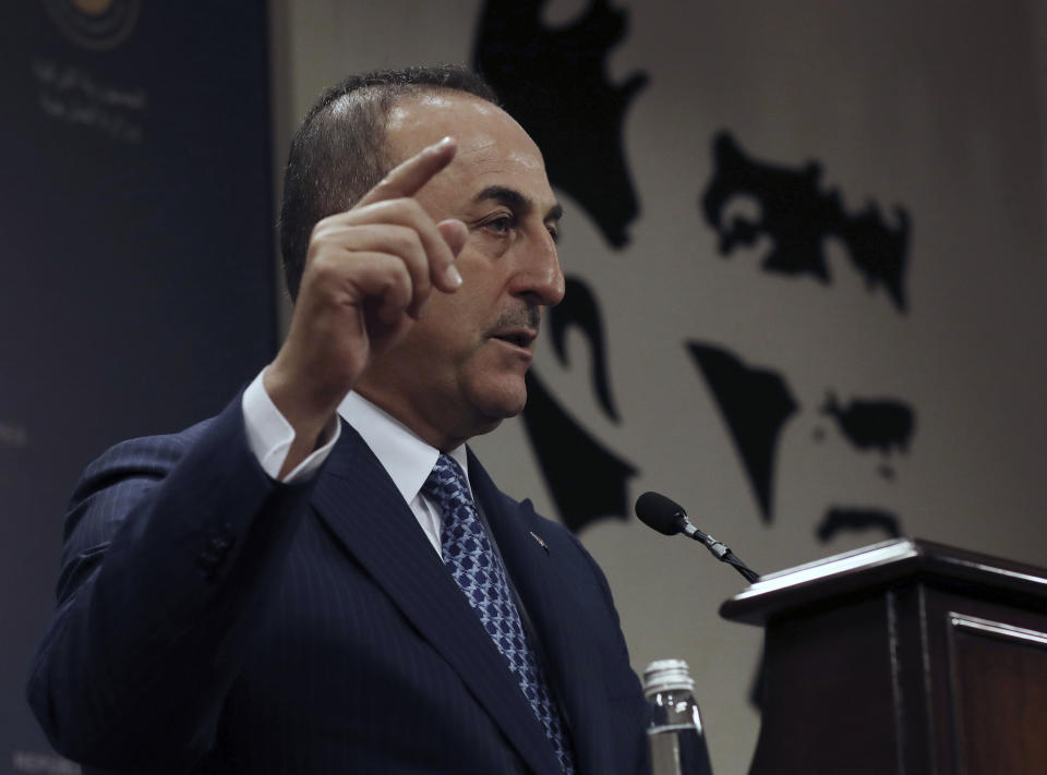 Turkey's Foreign Minister Mevlut Cavusoglu speaks during a joint news conference with Guinea-Bissau Foreign Minister Suzi Carla Barbosa, in Ankara, Turkey, Monday, Oct. 28, 2019. Cavusoglu says the Turkish military will attack any Syrian Kurdish fighter that remains along the border area in northeast Syria after a deadline for them to leave expires.(AP Photo/Burhan Ozbilici)
