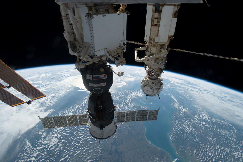 The damaged Soyuz MS-22/68S crew ship, its solar wings extended, is seen docked to the Earth-facing port of the Russian Rassvet module (lower center). The Russian Nauka laboratory module is visible to the right. / Credit: NASA