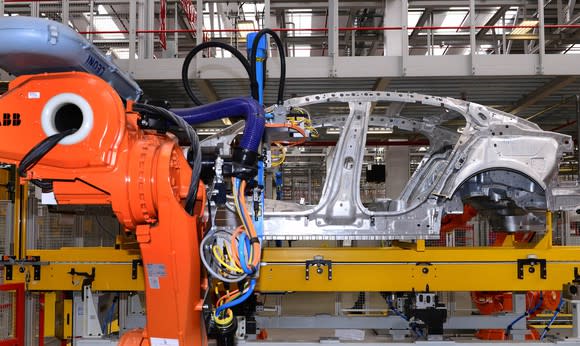 A Jaguar XE sedan's frame is shown on an assembly line at a factory in Castle Bromwich, England.
