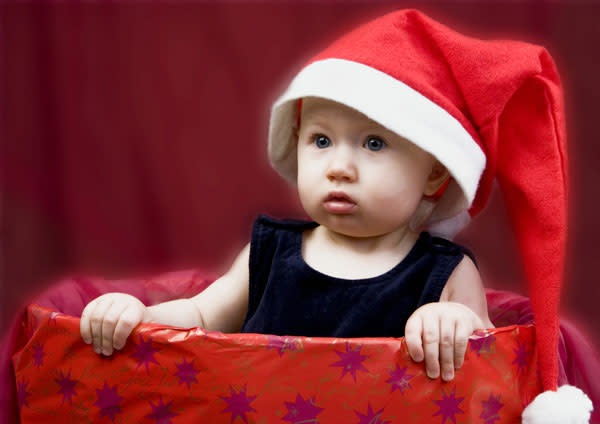 <b>Top 10 cute baby Christmas outfits </b><br><br>This little one doesn't look too happy to be wrapped up at Christmastime...<br><br>© Rex