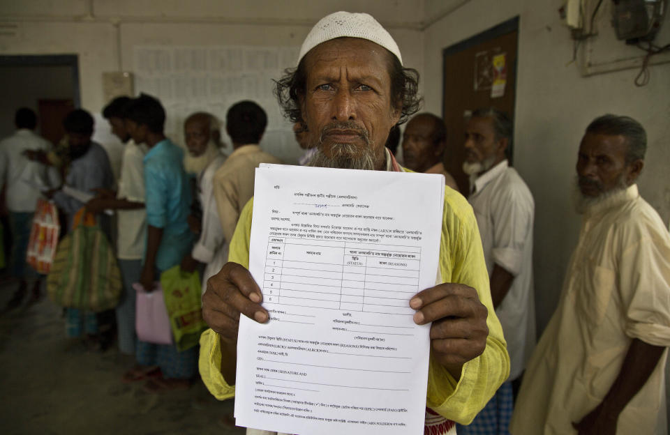 Kismat Ali, whose wife's name did not appear on the National Register of Citizens (NRC) draft, shows a form he collected to file an appeal in Mayong, 45 kilometers (28 miles) east of Gauhati, India, Friday, Aug. 10, 2018. On Friday, the 3.9 million residents left off Assam’s draft list of citizens began filing their appeals, wading into a byzantine legal and bureaucratic process that many fear could lead to detention, expulsion or years in limbo. (AP Photo/Anupam Nath)