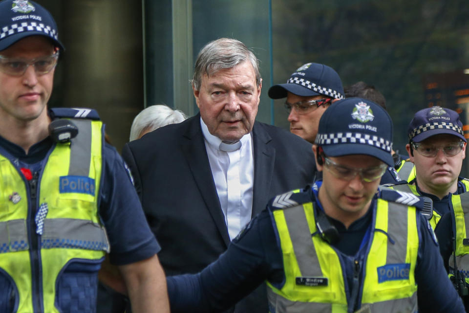 FILE - Cardinal George Pell, center, the most senior Catholic cleric to face sex charges, leaves court in Melbourne, Australia, May 2, 2018. Pell, who was the most senior Catholic cleric to be convicted of child sex abuse before his convictions were later overturned, has died Tuesday, Jan. 10, 2023, in Rome at age 81. (AP Photo/Asanka Brendon Ratnayake, File)