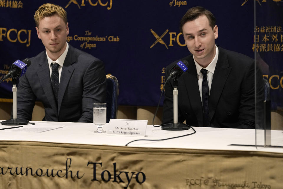 Ukraine's YouTubers, Sava Tkachov, right, speaks during a news conference, as his young brother Yan Tkachov listens to him at the Foreign Correspondents Club of Japan in Tokyo, Thursday, March 31, 2022. (AP Photo/Shuji Kajiyama)