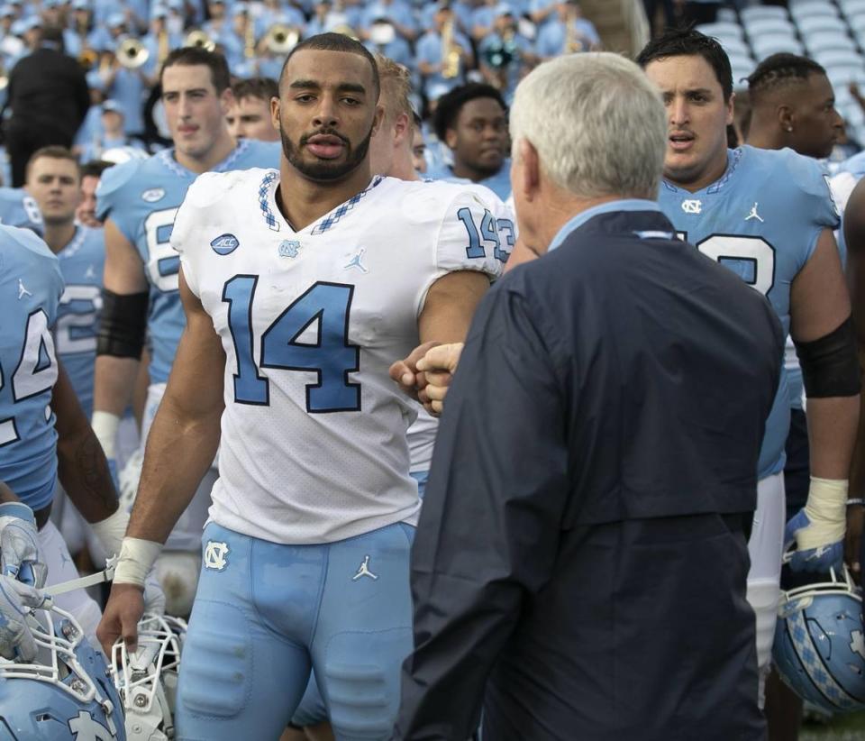 Jake Lawler gets a fist bump from North Carolina coach Mack Brown after a Tar Heels spring football game at Kenan Stadium in Chapel Hill in 2019.