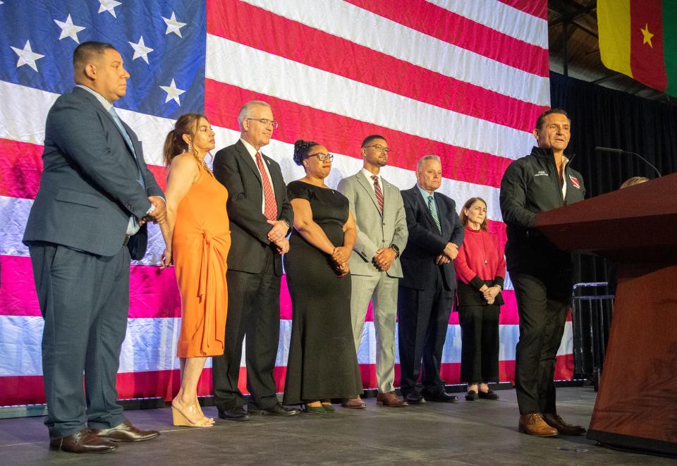 Juan E. Heredia, who volunteered his scuba diving skills to find the body of a Stagg student who drowned in the Calaveras River, speaks after receiving a key to to the city by Stockton at the annual State of the City event on by the chamber at the Port of Stockton on Apr. 18, 2024. Standing behind Heredia is the Stockton City Council, Brando Villapudua, left, Michele Padilla, Michael Blower, Kimberly Warmsely, Kevin Lincoln, Dan Wright and Susan Lenz.