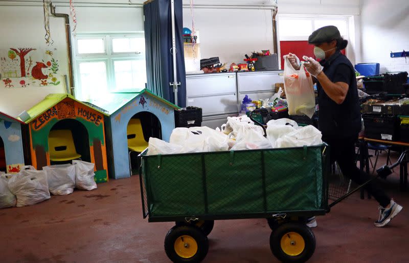 Volunteer Kingsley Ellis sorts food items ready to be delivered to local residents at a food bank in the Docklands Settlements Community Centre, as the spread of the coronavirus disease (COVID-19) continues, in east London