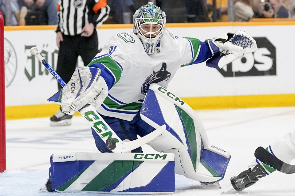 Vancouver Canucks goaltender Arturs Silovs (31) blocks a shot on goal against the Nashville Predators during the second period in Game 4 of an NHL hockey Stanley Cup first-round playoff series Sunday, April 28, 2024, in Nashville, Tenn. (AP Photo/George Walker IV)