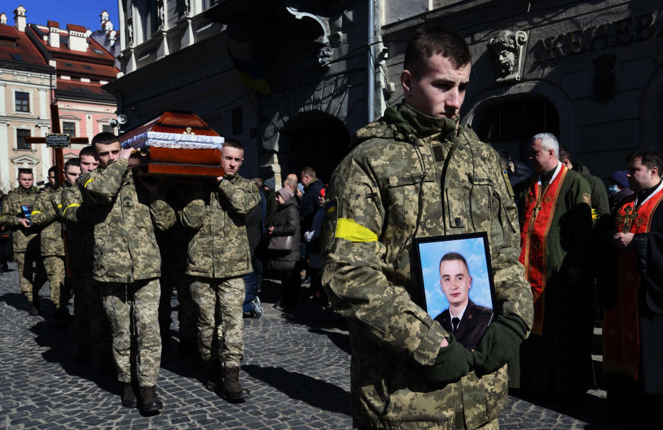 A funeral procession for three soldiers killed in the Russian invasion.