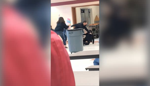 PHOTO: An off-duty police officer responds to a fight between two students at Lincoln Middle School in Kenosha, Wis., on March 4, 2022, in a still image from video. The officer appeared to kneel on the neck of a student, prompting an investigation. (Courtesy of student at Lincoln Middle School)