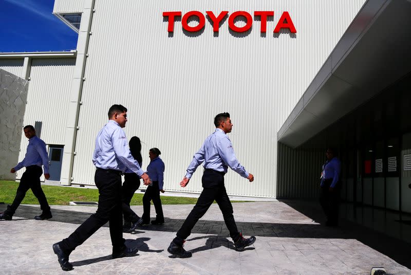 FILE PHOTO: Employees walk at the Toyota Motor Corp new plant in Mexico's central state of Guanajuato