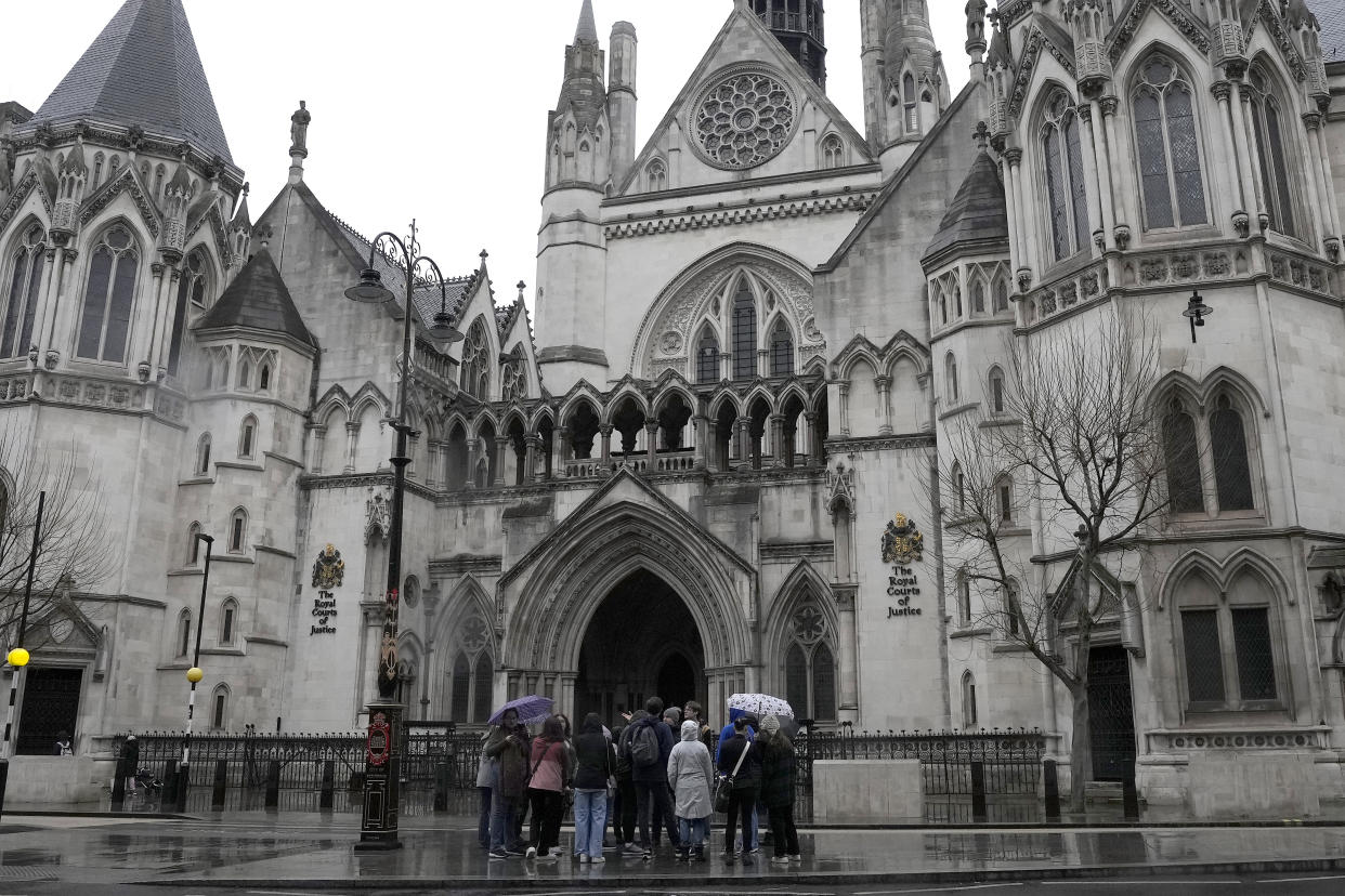 FILE - People stand outside the Royal Court of Justice in London, Friday, March 17, 2023. Prince Harry, the Duke of Sussex is scheduled to testify in the High Court after his lawyer presents opening statements Monday, June 5, 2023 in his case alleging phone hacking. It’s the first of Harry’s several legal cases against the media to go to trial and one of three alleging tabloid publishers unlawfully snooped on him. (AP Photo/Frank Augstein, File)