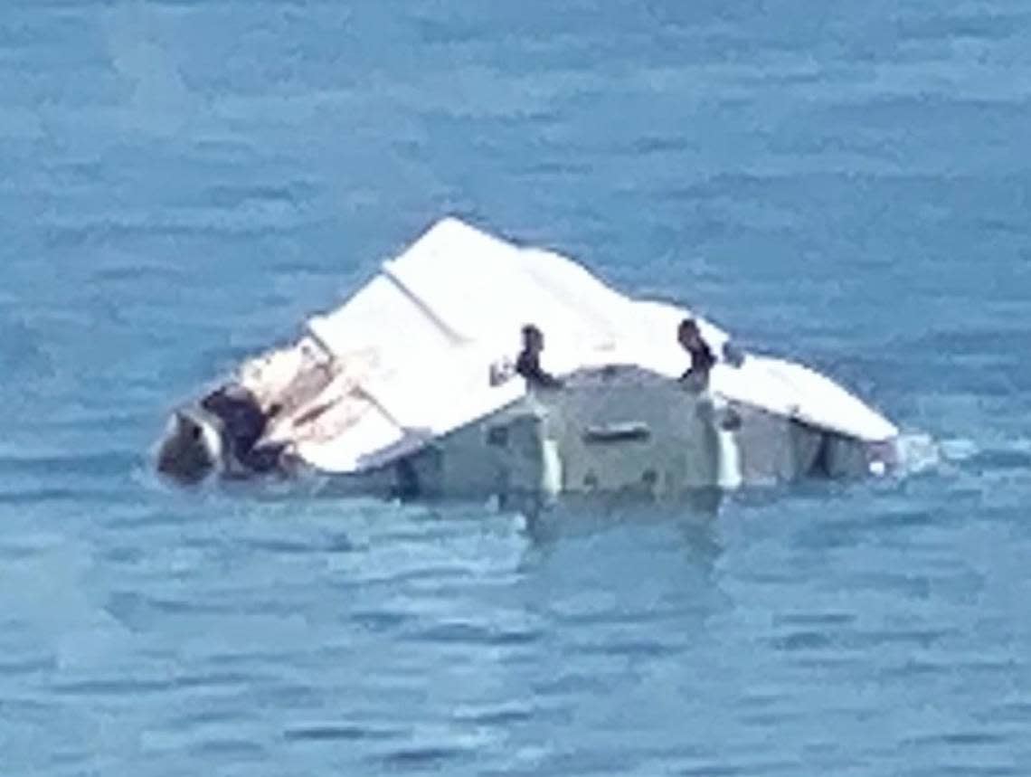 The boat that struck a channel marker near North Key Largo over Labor Day weekend capsized, throwing all aboard into the water. This photo taken on the scene, shows the upside-down vessel also had heavy damage along its starboard, or right, side. One young girl died in the wreck and another is fighting for her life.