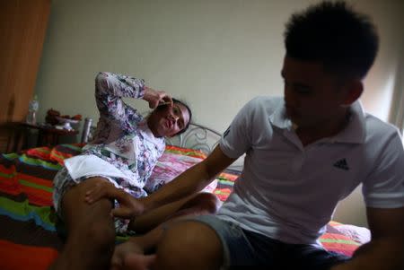 Muay Thai boxer Nong Rose Baan Charoensuk, 21, who is transgender, spends times with her boyfriend Beer at the Baan Charoensuk gym in Chachoengsao province, Thailand, July 12, 2017. REUTERS/Athit Perawongmetha