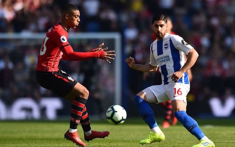 Southampton's French defender Yan Valery (L) vies with Brighton's Iranian midfielder Alireza Jahanbakhsh - Credit: GLYN KIRK/AFP