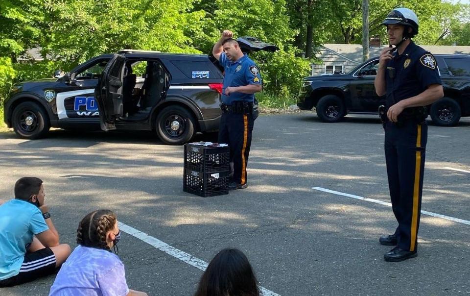 Detective Capt. Joseph Rooney, far right, is pictured in May 2021 as he shared bicycle and pedestrian safety tips with fifth grade students at Randal Carter School on Alps Road.