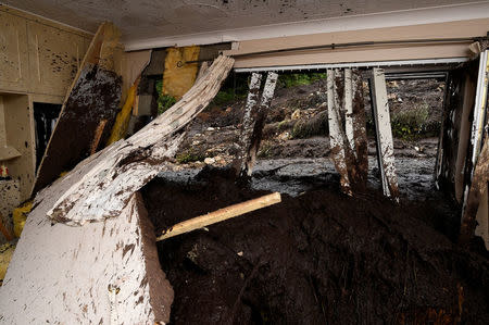 Bernie Kearney's bedroom in her destroyed home is seen, after a landslide carrying a boulder and her car came through the house, during torrential rains in Urris, County Donegal, Ireland August 24, 2017. REUTERS/Clodagh Kilcoyne