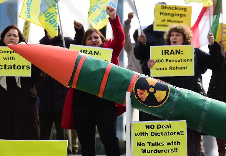 Iranian opposition supporters stage a demonstration displaying a fake nuclear missile ahead of nuclear talks between EU foreign ministers and Iran