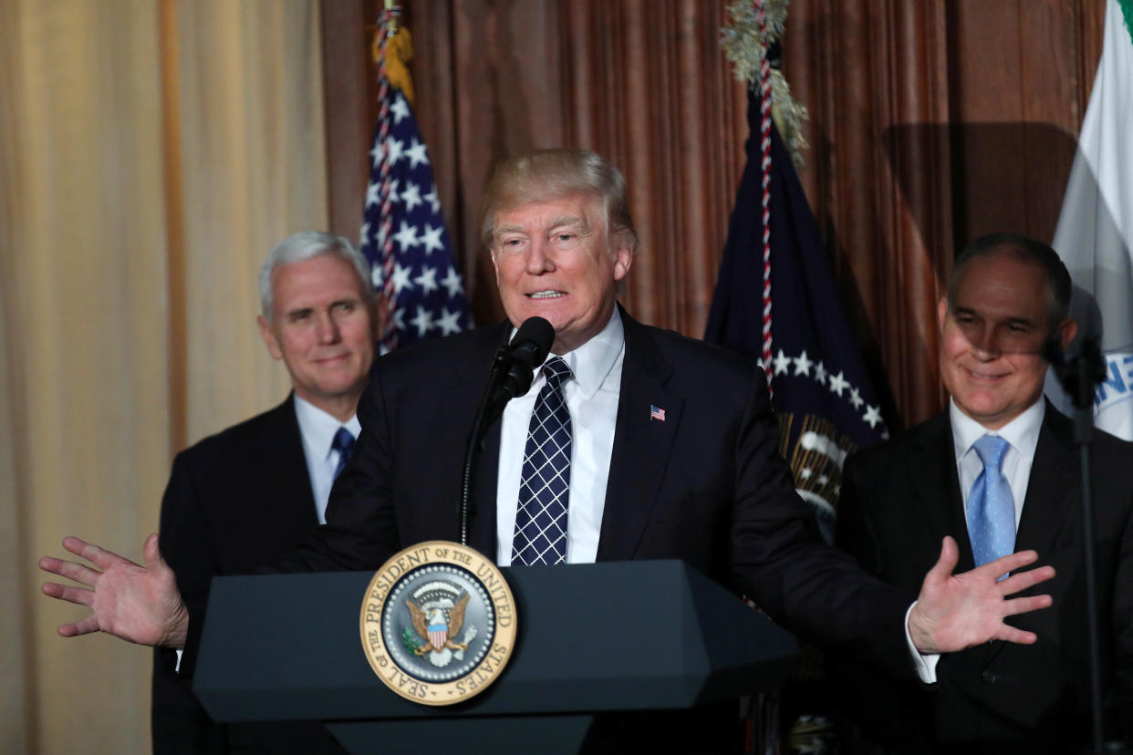 President Donald Trump, flanked by&nbsp;Vice President Mike Pence, left, and&nbsp;Environmental Protection Agency&nbsp;Administrator Scott Pruitt, plans to cut funding to the EPA to $5.65 billion. (Photo: Carlos Barria/Reuters)