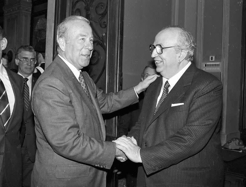 FILE PHOTO: U.S. Secretary of State George Shultz is greeted by Italian Defense Minister Giovanni Spadolini as he arrives in the latter's office at the Defense Ministry in Rome
