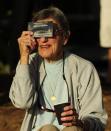 PALM COVE, AUSTRALIA - NOVEMBER 14: A spectator views the solar eclipse through special eclipse viewing glasses on November 14, 2012 in Palm Cove, Australia. Thousands of eclipse-watchers have gathered in part of North Queensland to enjoy the solar eclipse, the first in Australia in a decade. (Photo by Ian Hitchcock/Getty Images)