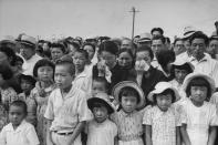 Caption from LIFE. "Japanese weep for dead friends and relatives while a memorial bell tolls at the exact hour of the [August 1945 Hiroshima] blast. A moment later they dried their eyes to watch a parade." (Carl Mydans—Time & Life Pictures/Getty Images) <br> <br> <a href="http://life.time.com/history/carl-mydans-hiroshima/#1" rel="nofollow noopener" target="_blank" data-ylk="slk:Click here;elm:context_link;itc:0;sec:content-canvas" class="link ">Click here</a> to see the full collection at LIFE.com