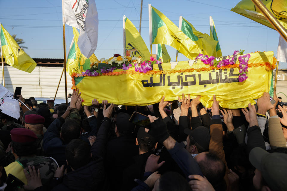 Fighters from the Popular Mobilization Forces, carry the coffin of a commander from the Kataib Hezbollah paramilitary group, Wissam Muhammad Sabir Al-Saadi, known as Abu Baqir Al-Saadi, who was killed in a U.S. airstrike, in Baghdad, Iraq, Thursday, Feb. 8, 2024. The U.S. military says a U.S. drone strike blew up a car in the Iraqi capital Wednesday night, killing the high-ranking commander. (AP Photo/Hadi Mizban)