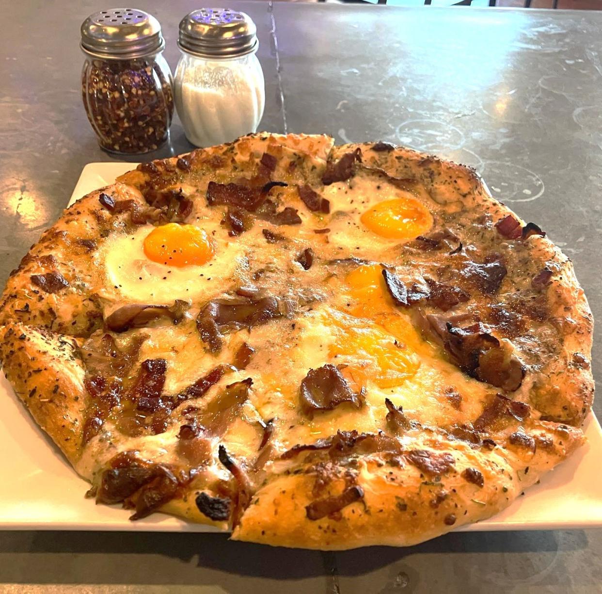 The Breakfast Pizza at Platypus & Gnome at 7205 Wrightsville Ave. near Wrightsville Beach, features a bison chorizo sausage gravy topped with sunny side up eggs, bacon, wild boar and their house gouda-cheddar cheese blend.