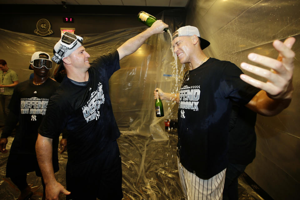 New York Yankees' Aaron Judge, right, celebrates with teammates after they clinched wildcard playoff berth with an 3-2 win over the Baltimore Orioles in a baseball game Saturday, Sept. 22, 2018, in New York. (AP Photo/Frank Franklin II)