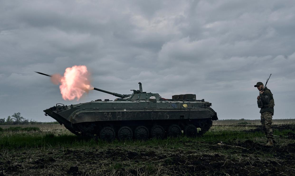 A Ukrainian APC fires towards Russian positions near Avdiivka, in the Donetsk region. Picture taken in April (AP)