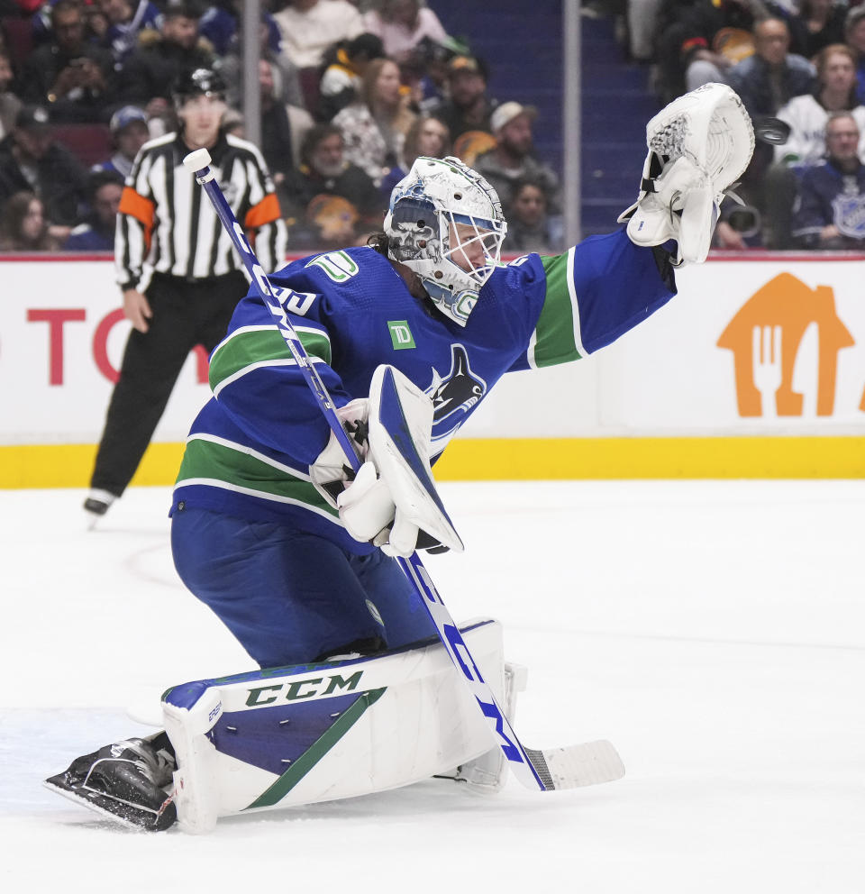 Vancouver Canucks goalie Thatcher Demko makes a glove save during the second period of an NHL hockey game against the Carolina Hurricanes in Vancouver, British Columbia, on Monday, Oct. 24, 2022. (Darryl Dyck/The Canadian Press via AP)