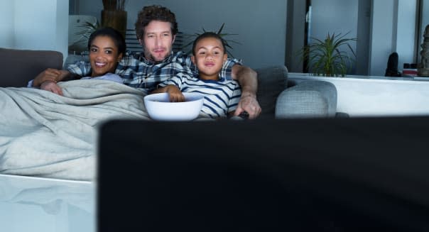 Family having popcorn while watching TV